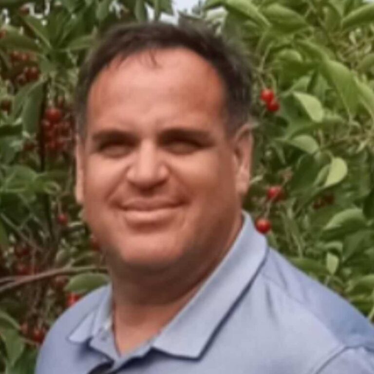 Eric, the owner of Property Rescue, in front of cherry trees.