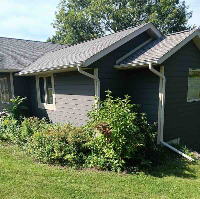 Modern gray house with garden plants
