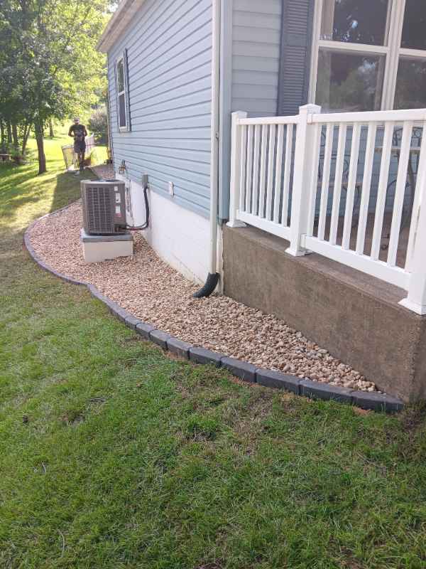 House exterior with gravel and air conditioning unit