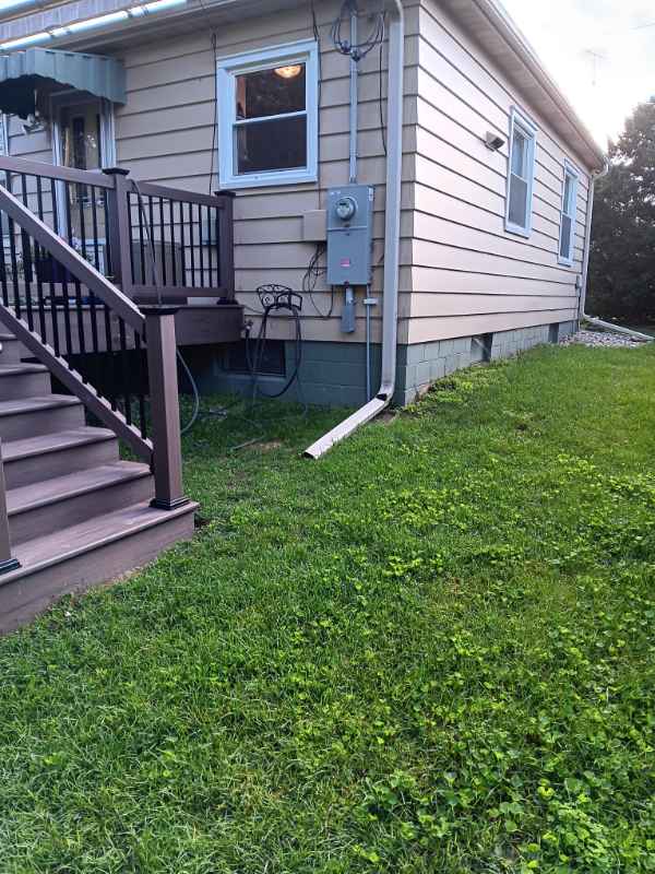 Backyard with house, stairs, and green lawn