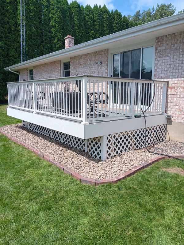 Outdoor patio deck with railing and seating