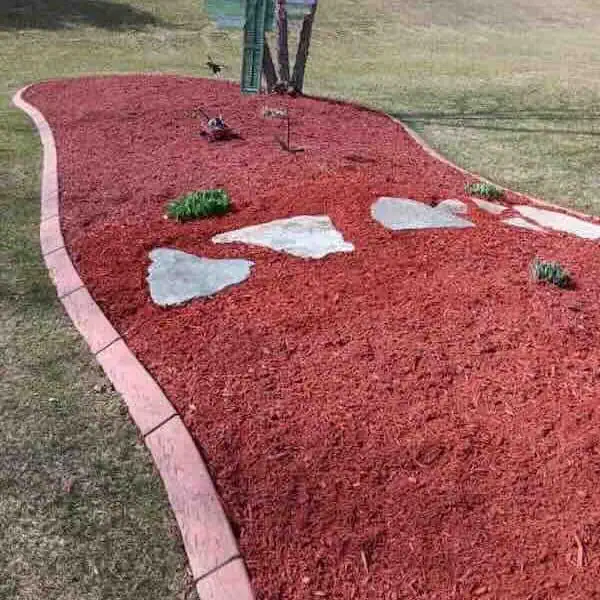 Mulch garden bed with stones and plants